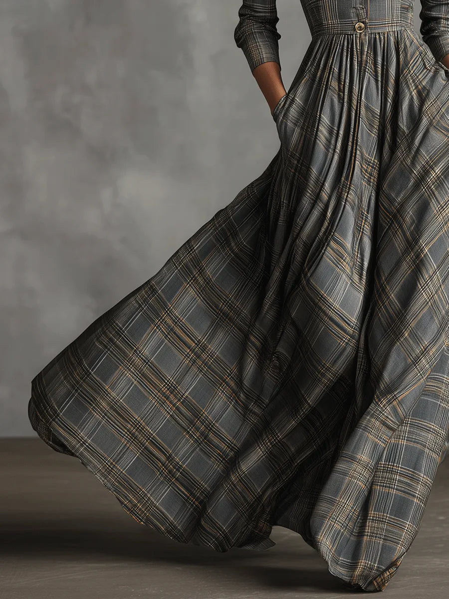 Detail shot of the flared skirt in grey tartan fabric showing soft pleats and hand resting in the side pocket