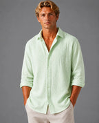 Man wearing a light green textured cotton shirt, front view, with hand in pocket