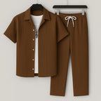 Brown textured ribbed short-sleeve shirt and matching drawstring trousers on hangers, worn over a white tee