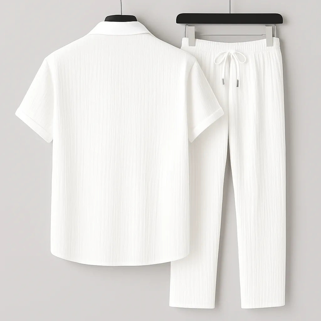 Back view of the white ribbed shirt and trousers set on hangers, showing the point collar and drawstring waist detail