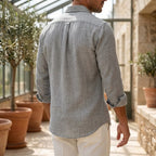 Back view of the heathered grey shirt showing the box pleat, curved hem and rolled-up cuffs