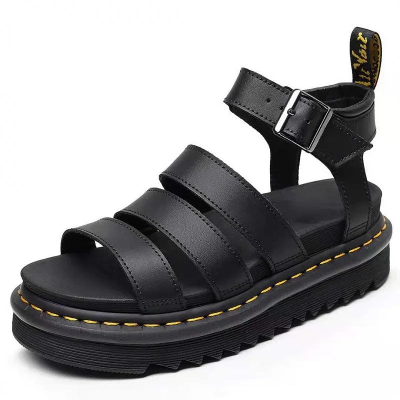 Angled front view of black faux leather platform sandal showing three wide straps and ankle buckle closure