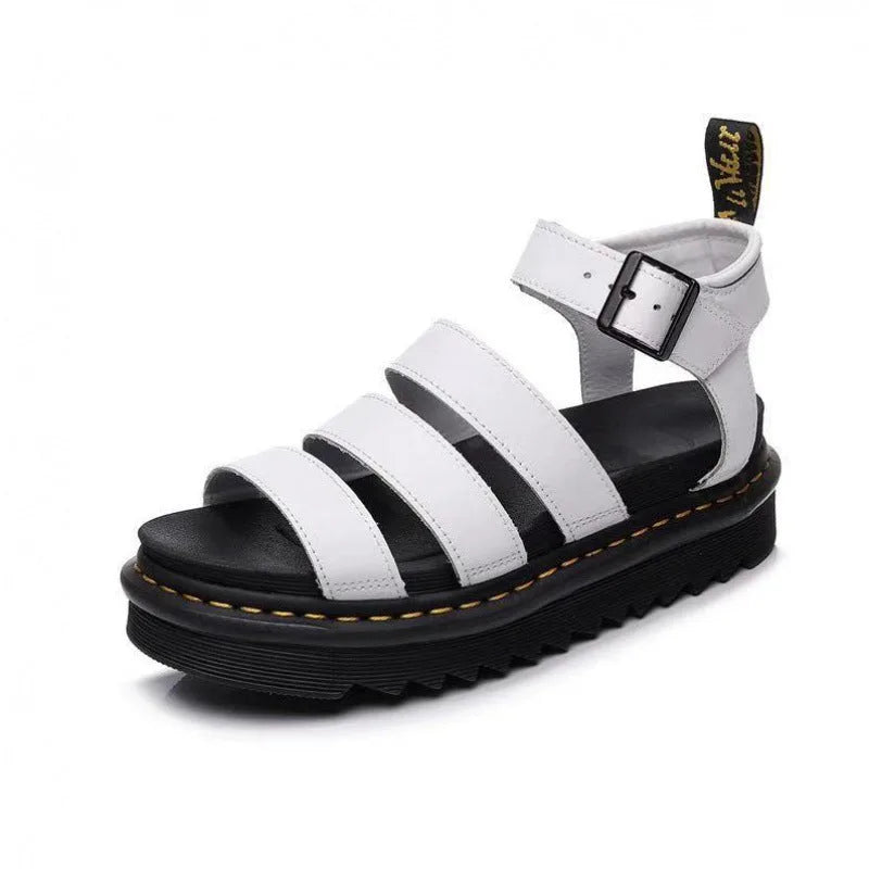 White platform sandal with triple front straps, silver buckle and black sole, shown at an angle