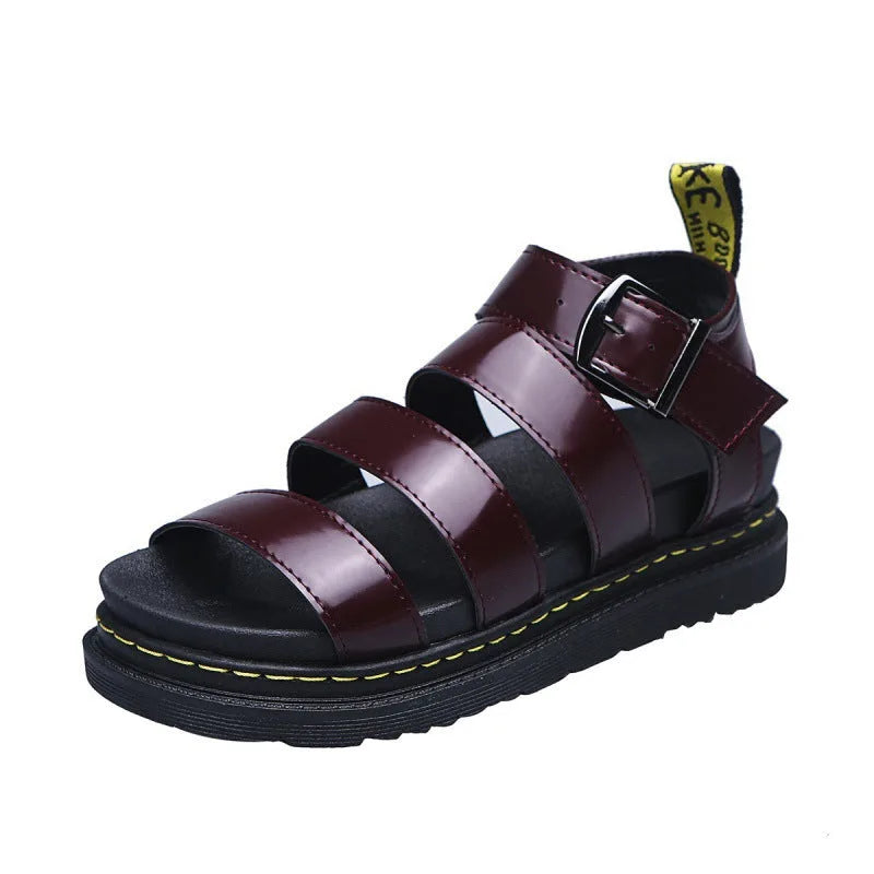 Deep burgundy platform sandal with glossy straps, metal buckle and yellow contrast stitching on sole