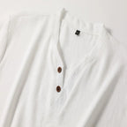 Flat lay close-up of the white henley collar showing the two brown buttons and stitched V-neck placket