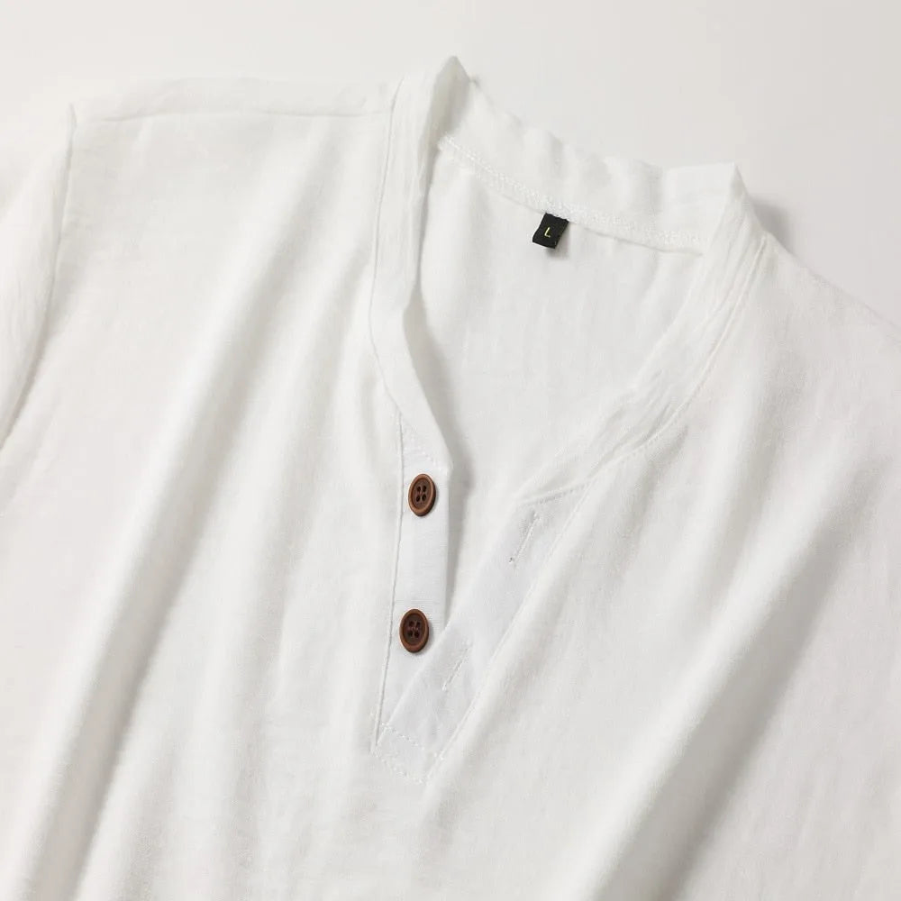Flat lay close-up of the white henley collar showing the two brown buttons and stitched V-neck placket