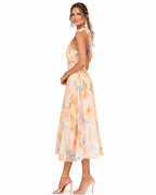 Side profile showing the fitted waist and full flowing skirt of the watercolour print halter dress