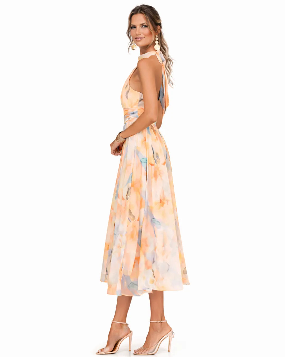 Side profile showing the fitted waist and full flowing skirt of the watercolour print halter dress