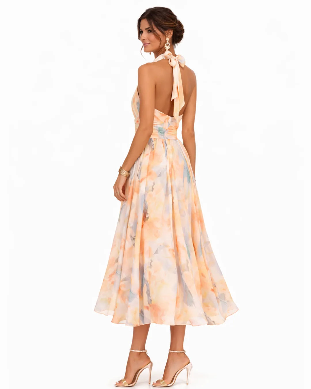 Back view highlighting the open back, tie halter neck and bow detail of the floral midi dress