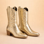 Front pair view of gold metallic cowboy boots showing side zip, pointed toes and stacked heel