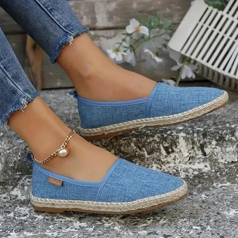 Pale blue woven espadrille flat worn with cropped denim jeans and a gold anklet