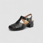 Angled studio shot of black leather woven sandal with slingback strap and stacked block heel