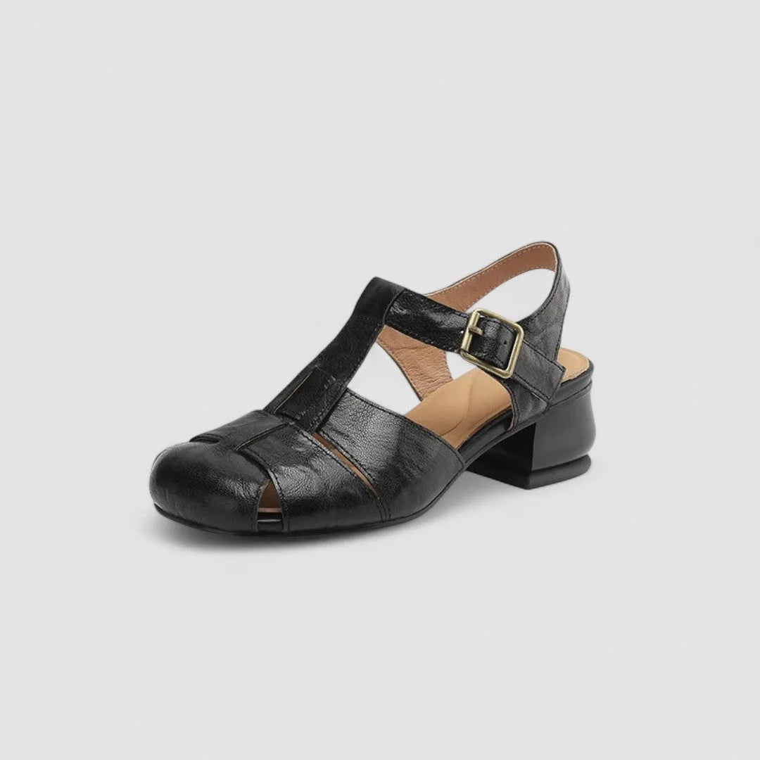 Angled studio shot of black leather woven sandal with slingback strap and stacked block heel
