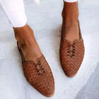 Overhead view of tan woven leather flats highlighting the braided texture and slingback strap