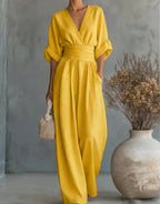 Full-length front view of the burgundy jumpsuit showing its relaxed wide-leg silhouette