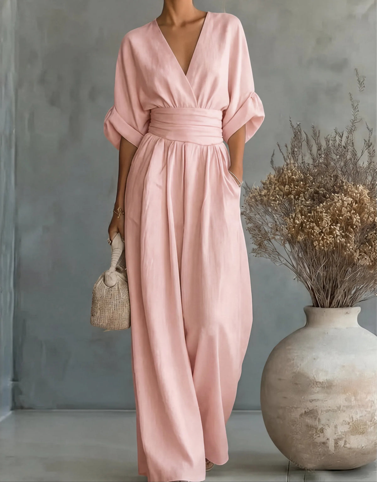Burgundy jumpsuit styled with a woven handbag for a café outing