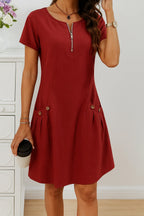 Rust red midi dress shown from the front, showcasing the metallic zip pull and relaxed fit through the waist