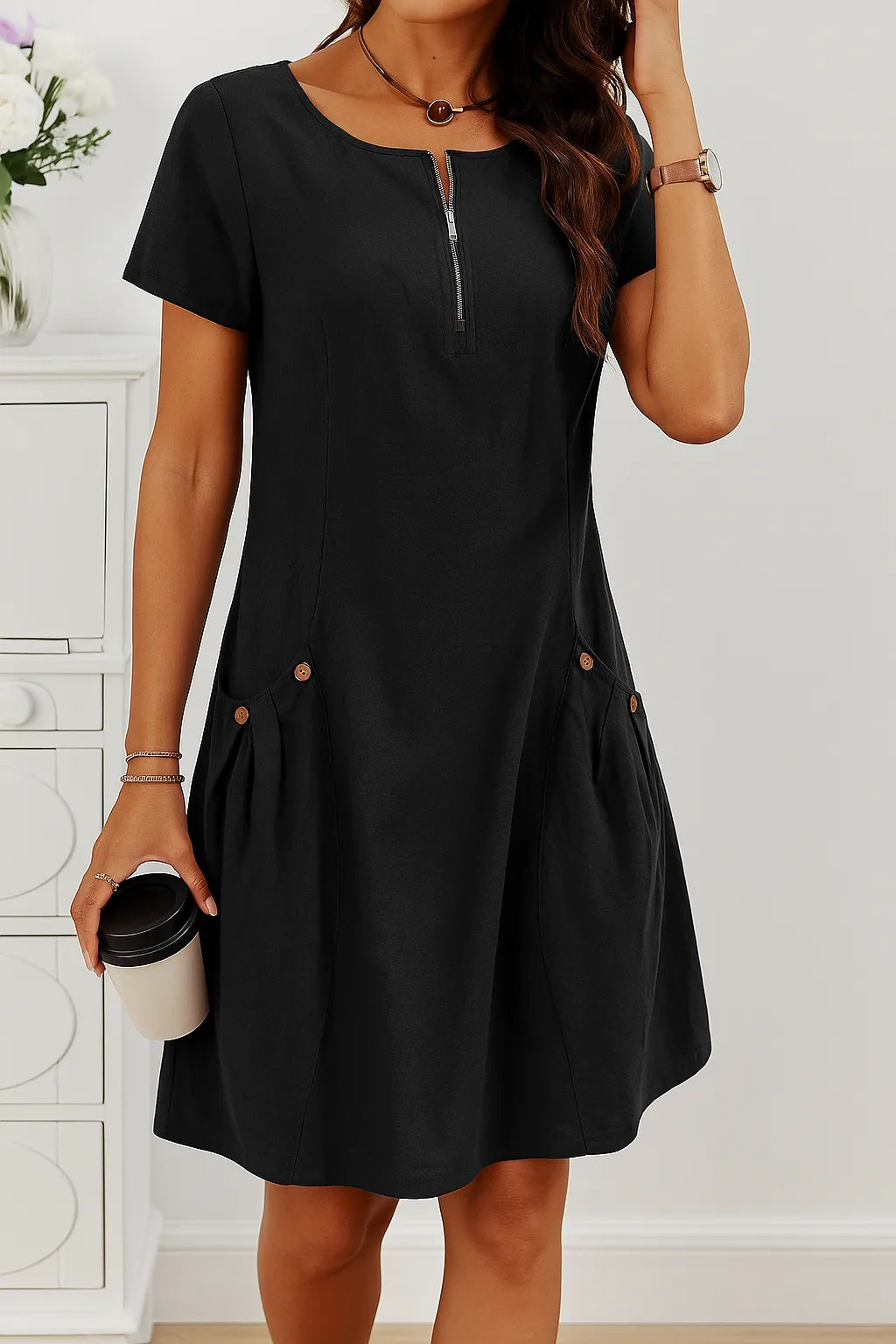 Black midi dress worn with a round pendant necklace, displaying the zip neckline and tonal button pocket detail